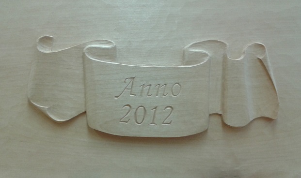 Relief: Anno 2012 Schriftzug mit Schleifenband